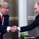 Russian President Vladimir Putin and US President Donald Trump shake hands.