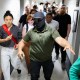 An ICE agent in a mask leads the way as a man is detained after his immigration court hearing in New York on June 6, 2025.