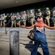 A protester in front of a line of California National Guard