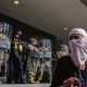 A protester stands in front of National Guardsmen outside of the Robert Young Federal Building on June 9, 2025 in downtown Los Angeles.
