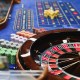 Casino Worker Arranging Roulette Table for Guests Stacking Gambling Chips