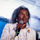 Winsome Earle-Sears holds a microphone on stage