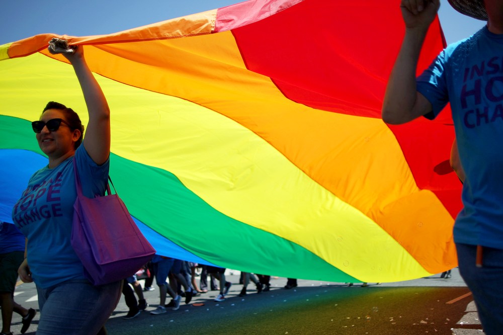 Marchers carry a rainbow flag in the LA Pride Parade on June 8, 2014 in West Hollywood, California.
