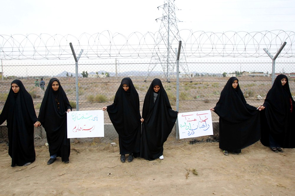 Iranian students form a human chain during a protest to defend their country's nuclear program outside the Fordo Uranium Conversion Facility in Qom, Nov. 19, 2013.