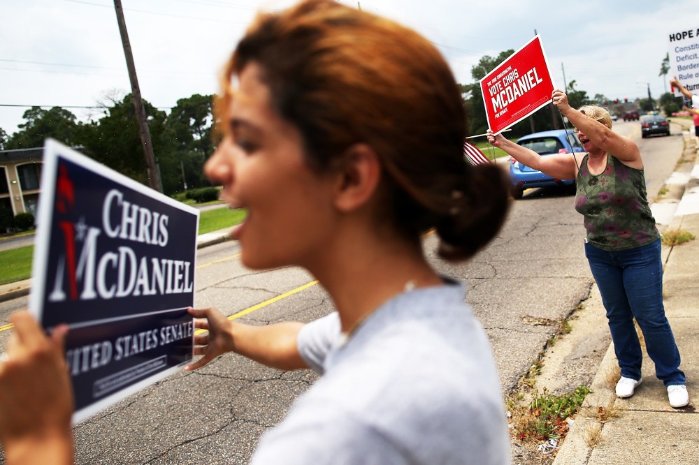 Supporters of Republican candidate for U.S. Senate, Mississippi State Sen. Chris McDaniel hold signs during a Tea Party Express campaign event in Biloxi, Mississippi, June 22, 2014.