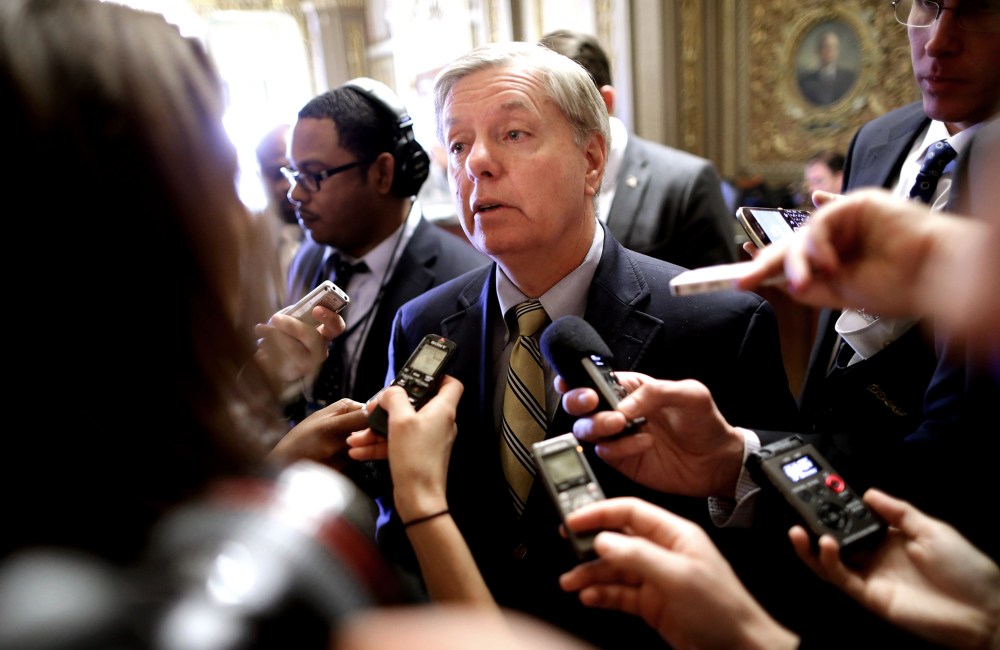 Sen. Lindsey Graham (R-SC) talks with reporters after stepping off the Senate floor at the U.S. Capitol Nov. 21, 2013 in Washington, DC.
