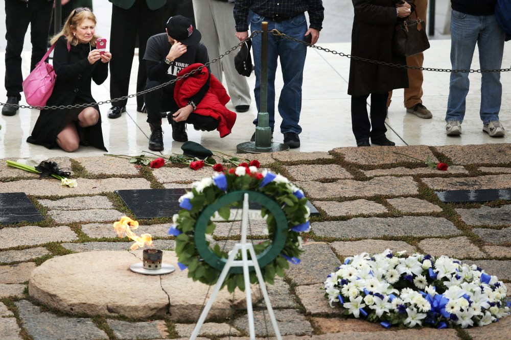 People visit the gravesite of former U.S. President John F. Kennedy at Arlington National Cemetery Nov, 22, 2013.