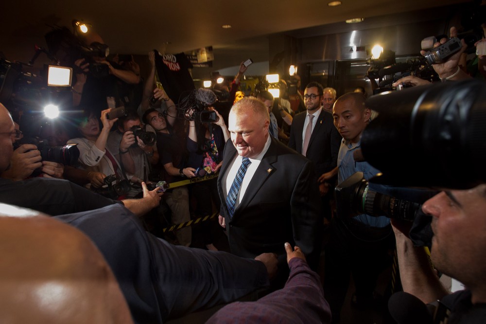 Toronto Mayor Rob Ford arrives at his office at city hall in Toronto on June 30, 2014 amid a crush of cameras.
