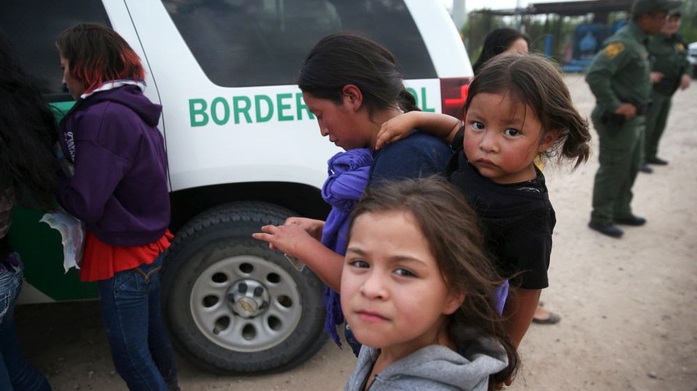 Central American immigrants await transportation to a U.S. Border Patrol processing center after crossing the Rio Grande from Mexico into the Texas on July 24, 2014 near Mission, Texas.