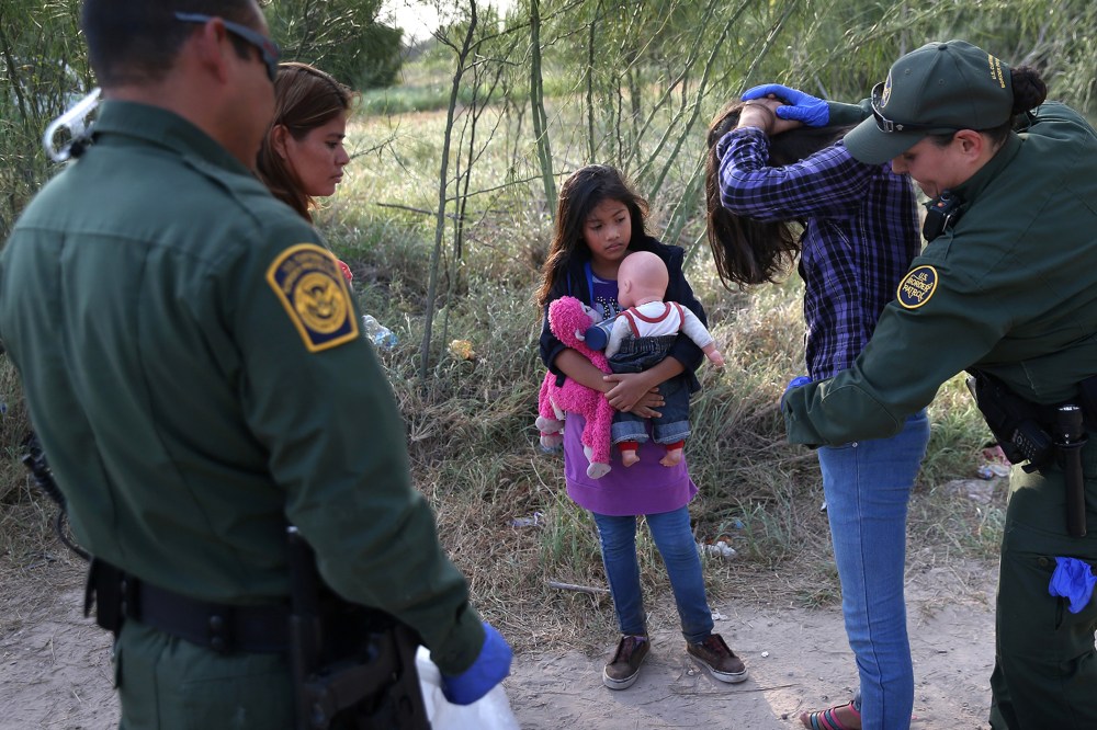 Salvadorian immigrant Stefany Marjorie, 8, watches as a Border Patrol agents body-searches her sister on July 24, 2014 in Mission, Texas.