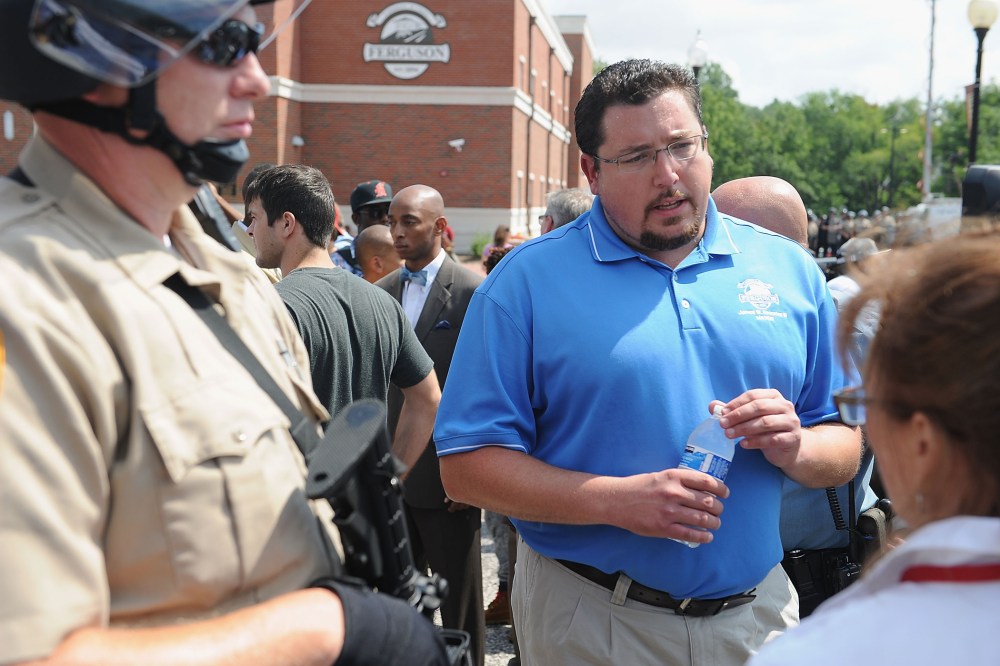 Ferguson Mayor James Knowles III (C) speaks to protestors during a protest of the shooting death of 18-year-old Michael Brown by a Ferguson police officer, outside Ferguson Police Department Headquarters Aug. 11, 2014 in Ferguson, Mo.