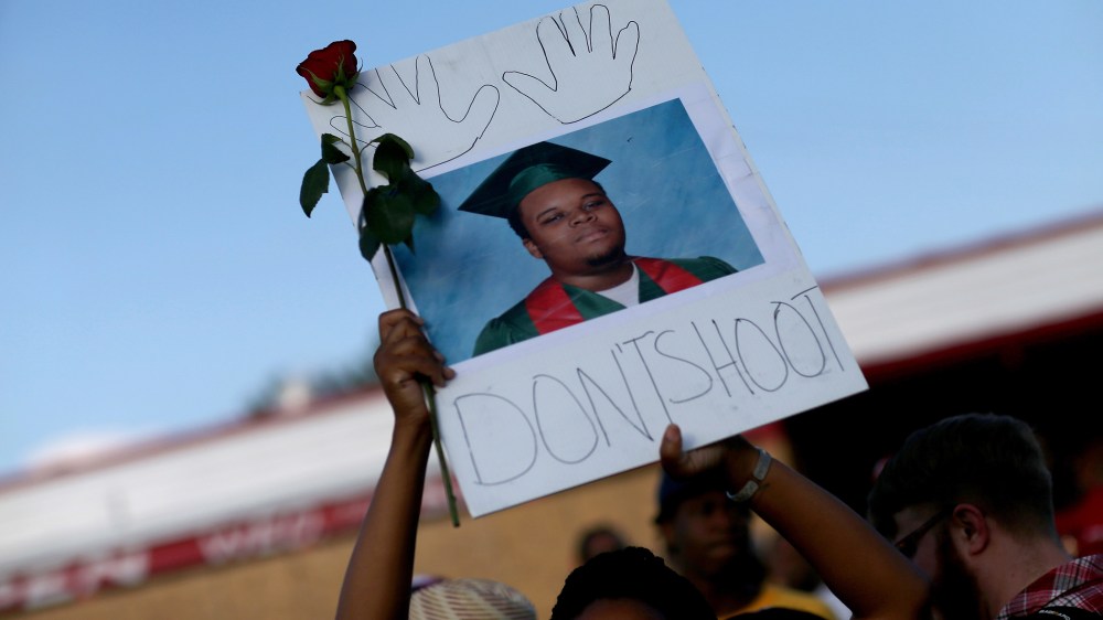 A demonstrator holds a sign reading, "Dont Shoot", with a picture of Michael Brown on Aug. 17, 2014 in Ferguson, Mo. (Photo by Joe Raedle/Getty)