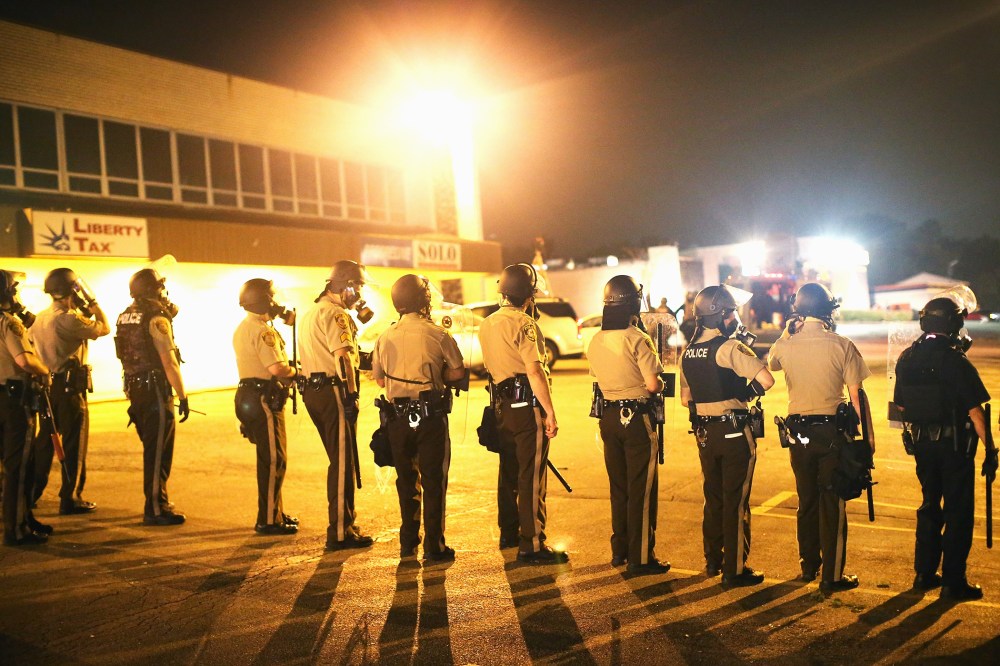 Police advance on demonstrators protesting the killing of teenager Michael Brown on August 17, 2014 in Ferguson, Missouri.