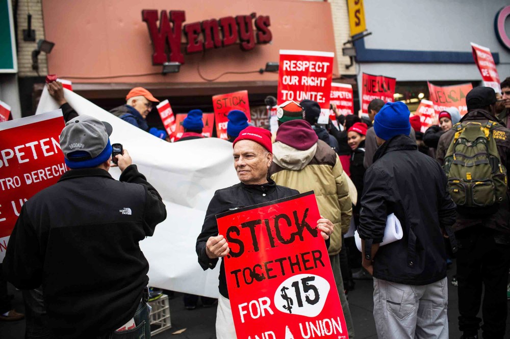Protesters rally outside of a Wendy's in support of raising fast food wages in Brooklyn, Dec. 5, 2013.