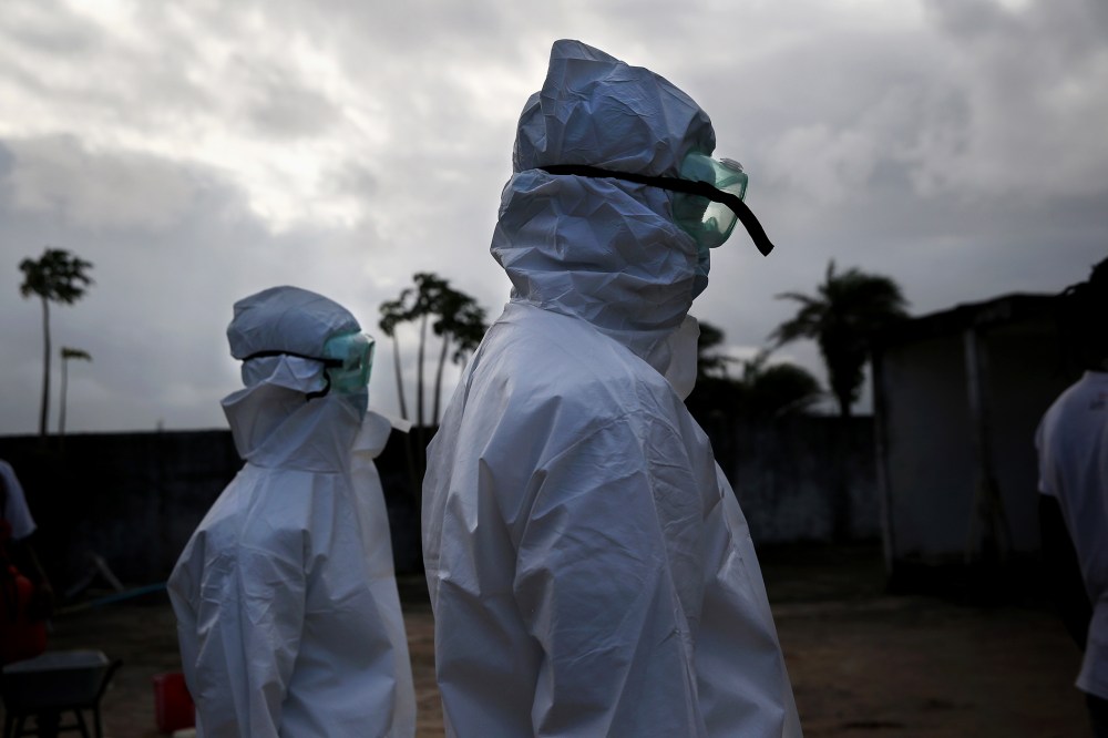 A burial team from the Liberian Ministry of Health prepares to unload the bodies of Ebola victims onto a funeral pyre at a crematorium on Aug. 22, 2014 in Marshall, Liberia.