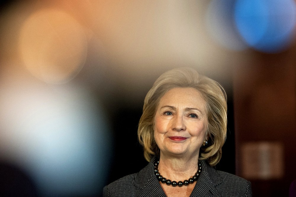 Former US Secretary of State Hillary Clinton listens to a speaker on Capitol Hill in Washington, D.C., on Dec. 6, 2013. (Photo by Nicholas Kamm/AFP/Getty)