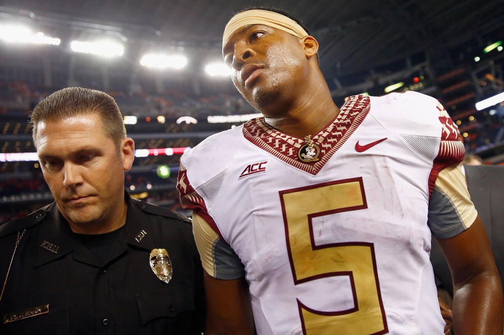 Jameis Winston of the Florida State Seminoles walks off the field after a game at AT&T Stadium on Aug. 30, 2014 in Arlington, Texas.  Photo by Tom Pennington/Getty