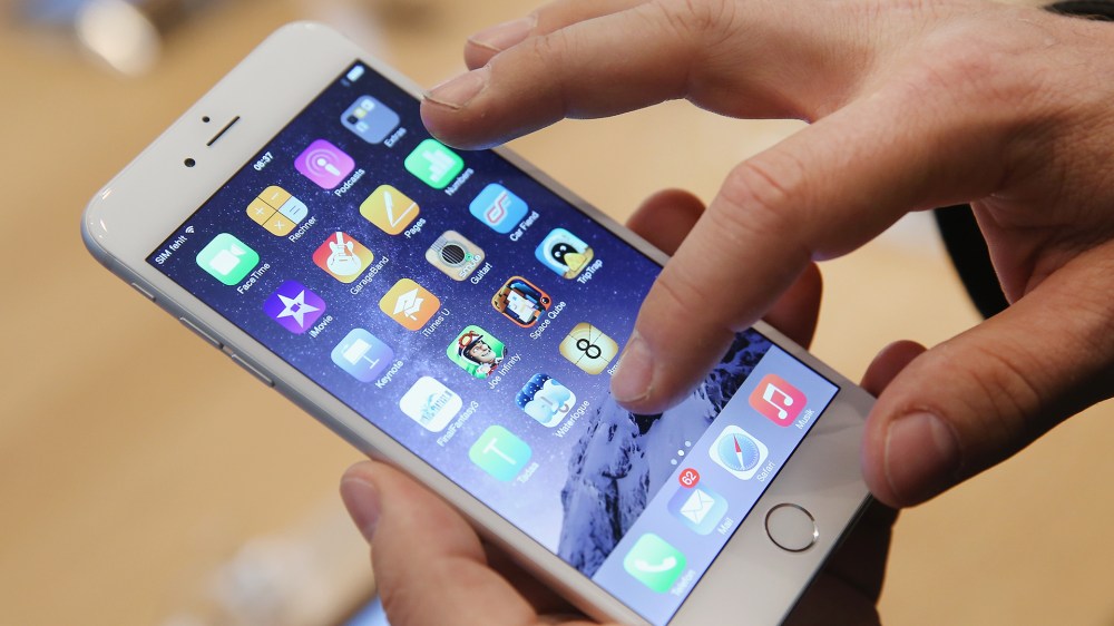 A shopper tries out the new Apple iPhone 6 at the Apple Store on the first day of sales of the new phone in Germany on September 19, 2014.