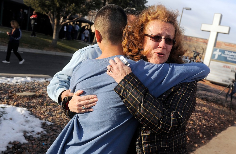 JoAnne Allen, right, hugs her son Alex Allen, 17, after a school shooting on December 13, 2013 at Arapahoe High School in Centennial, Colorado.