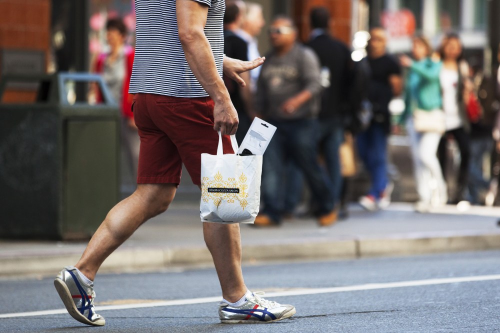 A man carries a plastic shopping bag on September 30, 2014 in San Francisco, California.