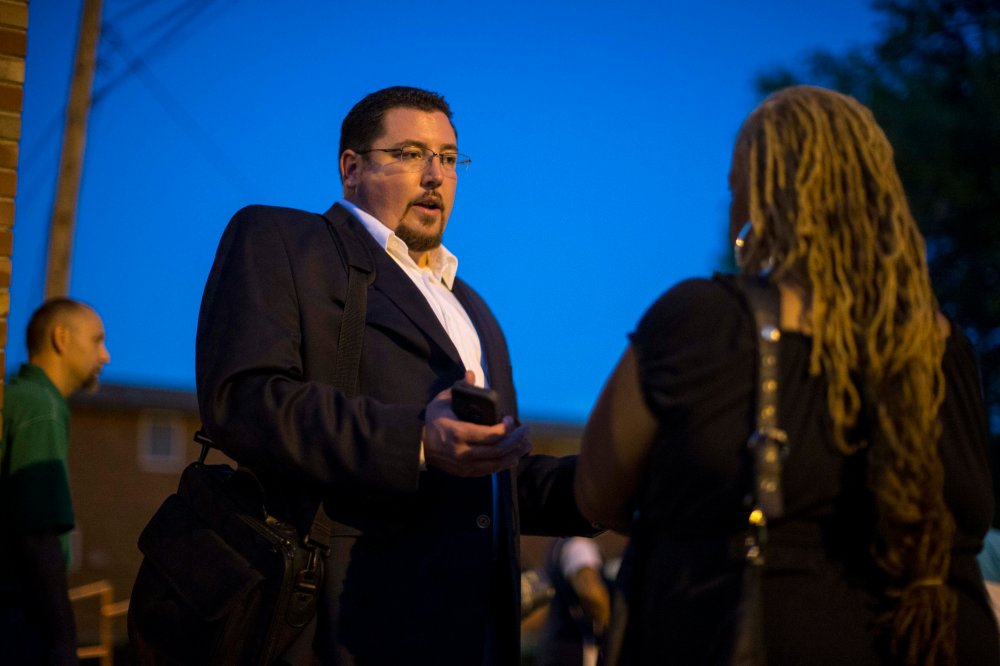 Ferguson Mayor James Knowles (L) speaks with resident Juanita Stone after a town hall meeting with local government officials and residents on Sept. 30, 2014 at Our Lady of Guadalupe in Ferguson, Mo. (Whitney Curtis/Getty)