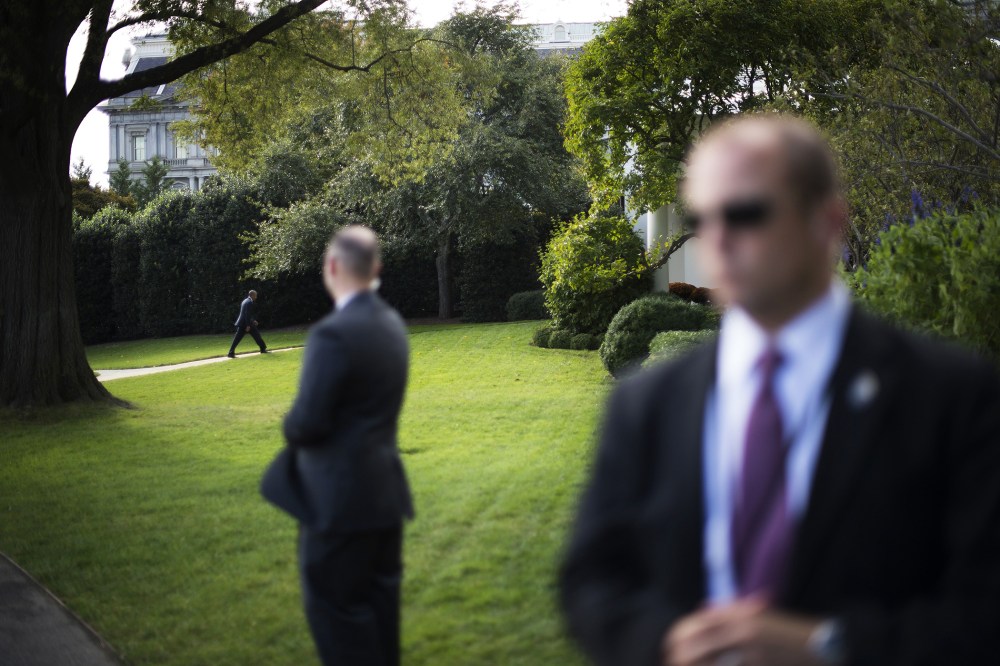 US Secret Service officers stand watch as US President Barack Obama returns to the Oval Office at the White House in Washington, D.C., Oct. 14, 2014. (Photo by Jim Watson/AFP/Getty)