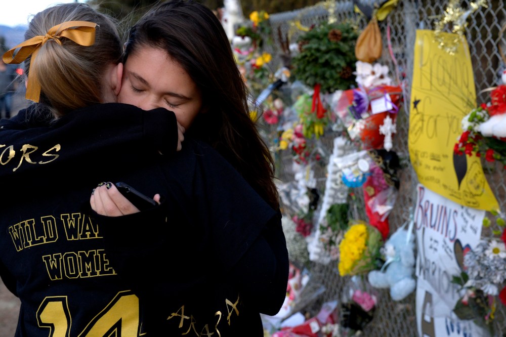 Seniors Lexi Barrent, right, and Melissa Tombaugh embrace outside Arapahoe High School in Centennial, CO Dec. 19, 2013