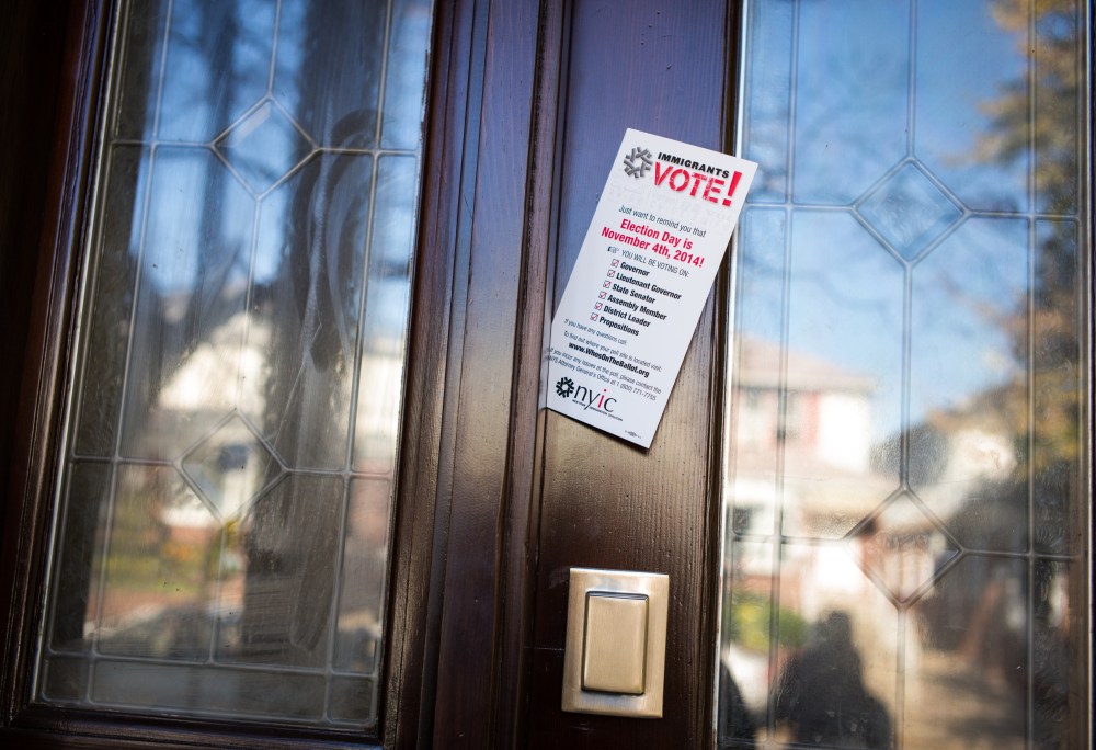 A pamphlet from the New York Immigrant Coalition is left in a door by volunteers from the Arab American Association of New York, AAANY, Nov. 4, 2014 in the Bay Ridge neighborhood of Brooklyn, N.Y. (Photo by Robert Nickelsberg/Getty)