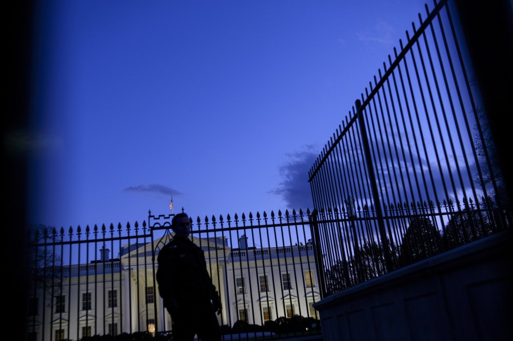 A member of the Secret Service's uniformed division stands by a fence in front of the White House on Nov. 20, 2014 in Washington, D.C. (Photo by Brendan Smialowski/AFP/Getty)