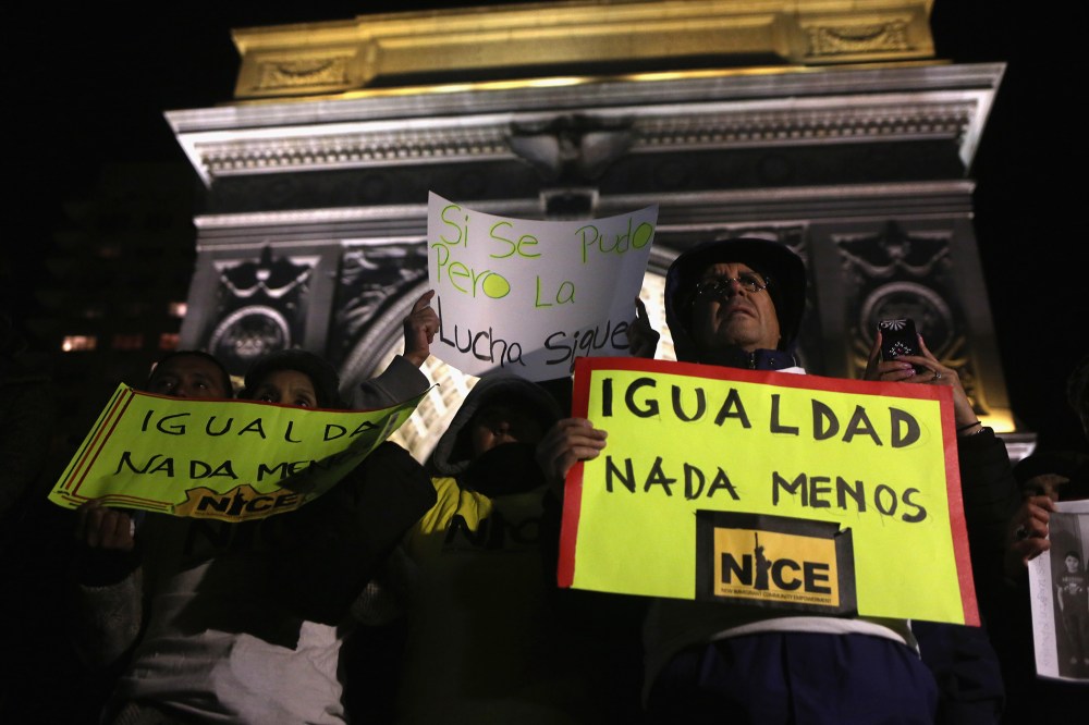 An activist holds a sign during a gathering to celebrate President Barack Obama's executive action on immigration policy in New York, N.Y., on Nov. 21, 2014. (Photo by John Moore/Getty)