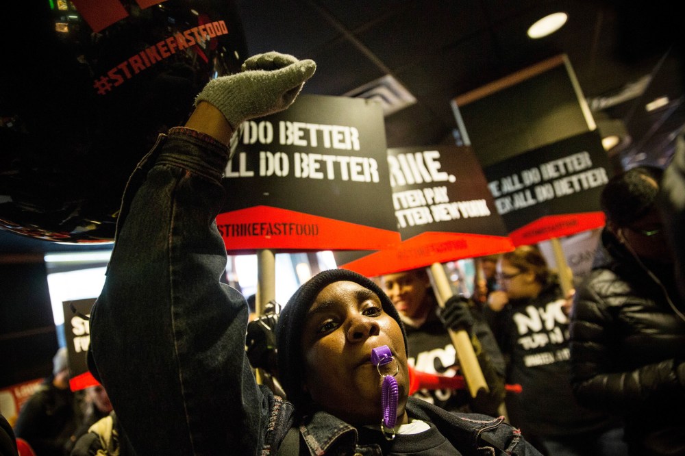 Protesters march through a McDonalds demanding a raise on the minimum wage to $15 per hour on Dec. 4, 2014 in New York.