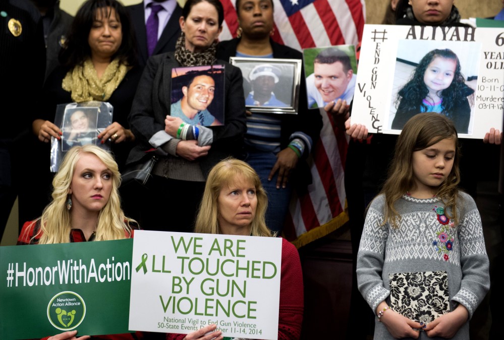 Gun violence advocates and relatives of victims during a press conference on the second anniversary of the shootings at Sandy Hook Elementary School in Newtown, Conn., in Washington, DC, Dec. 10, 2014. (Photo by Saul Loeb/AFP/Getty)