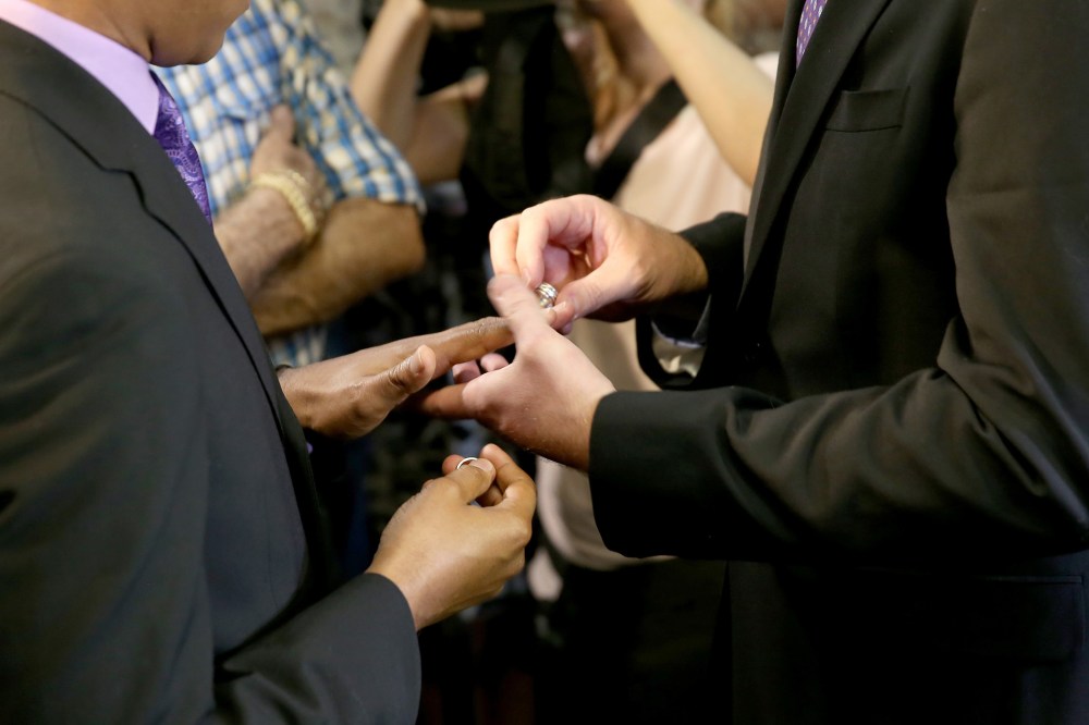 Newlyweds Jeff Delmay and Todd Delmay (L-R) exchange rings during a marriage ceremony in the Miami-Dade court room of Circuit Judge Sarah Zabel on Jan. 5, 2015 in Miami, Fla.