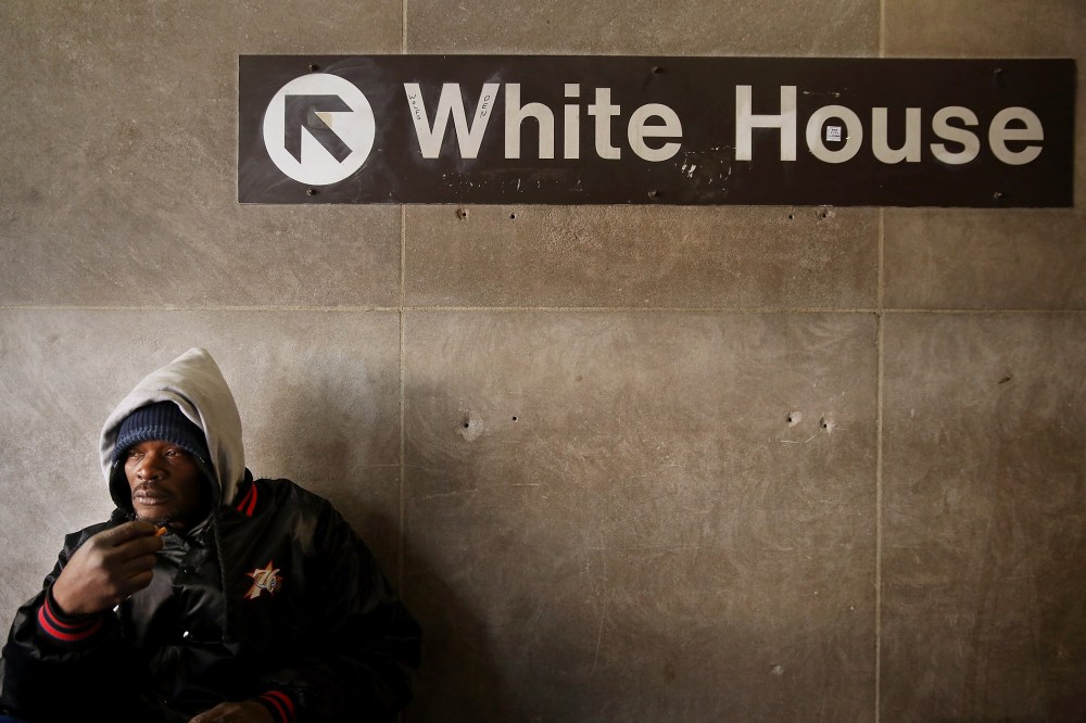 A homeless man steels himself against single-digit temperatures in the McPhearson Square Metro station in Washington, Jan. 7, 2014.