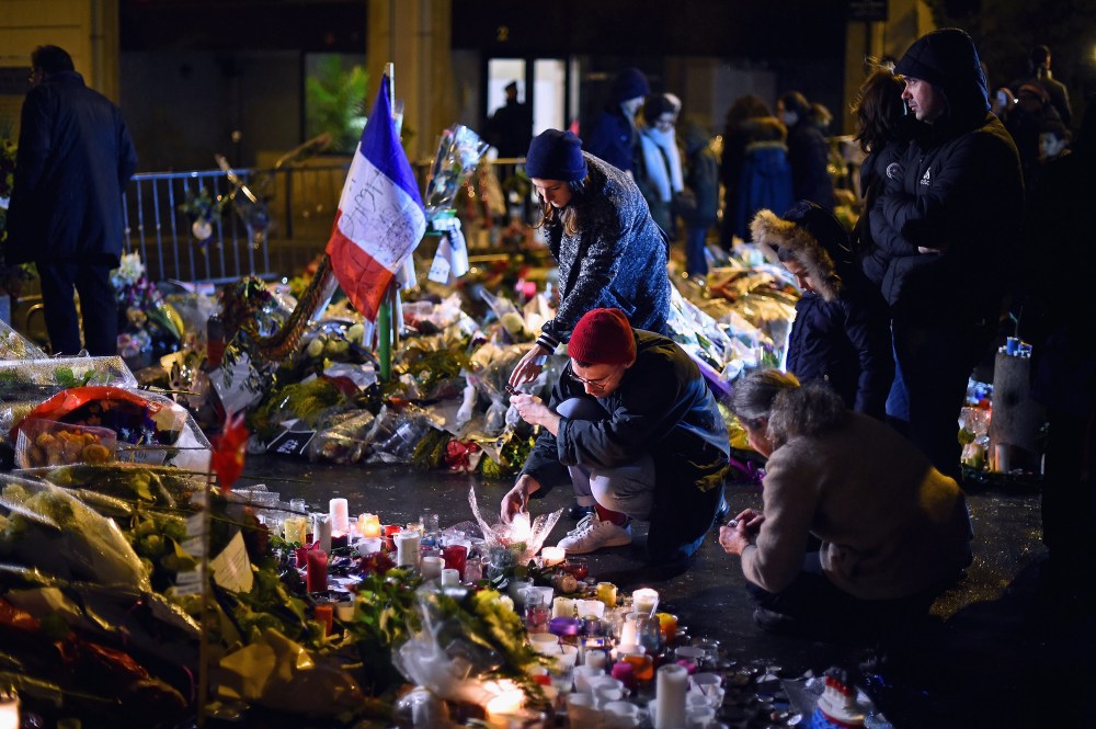 Members of the public light candles in tribute near the offices of French satirical magazine Charlie Hebdo on Jan. 10, 2015 in Paris, France. (Photo by Jeff J Mitchell/Getty)