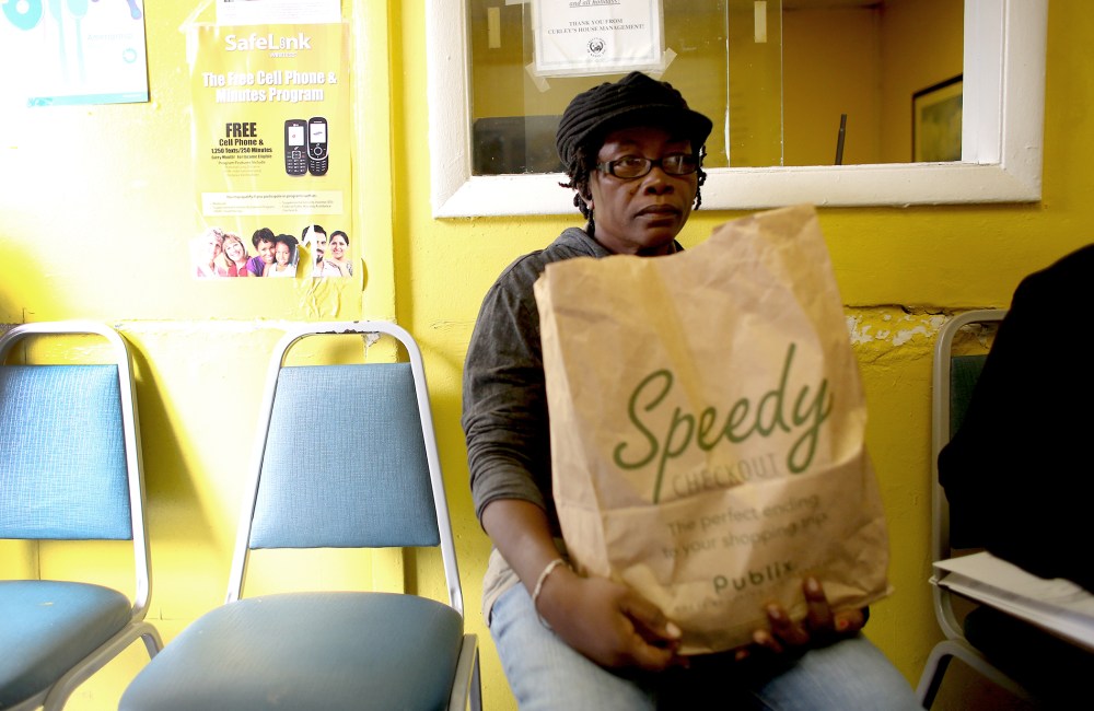 50 Years Since LBJ's War Of Hermita Santa Cruz holds her bag of groceries after receiving them from the Curly's House Hope Relief Food Bank on Jan. 8, 2014 in Miami, Florida.Poverty, Ranks Of The Poor Hold At 15 Percent