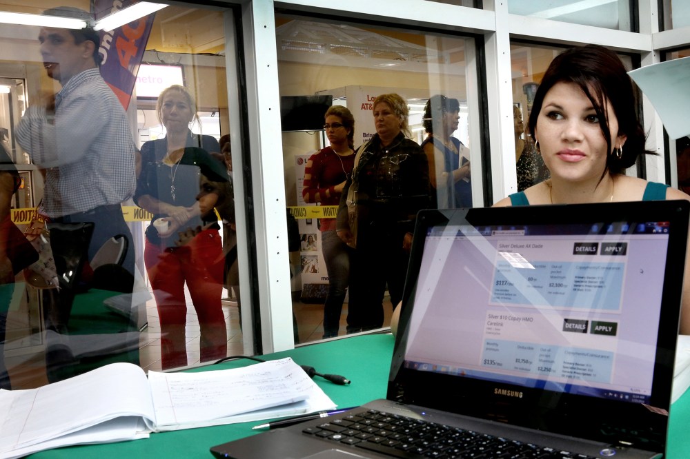 People stand in line to purchase health insurance under the Affordable Care Act in Miami, Fla. Jan. 15, 2014.