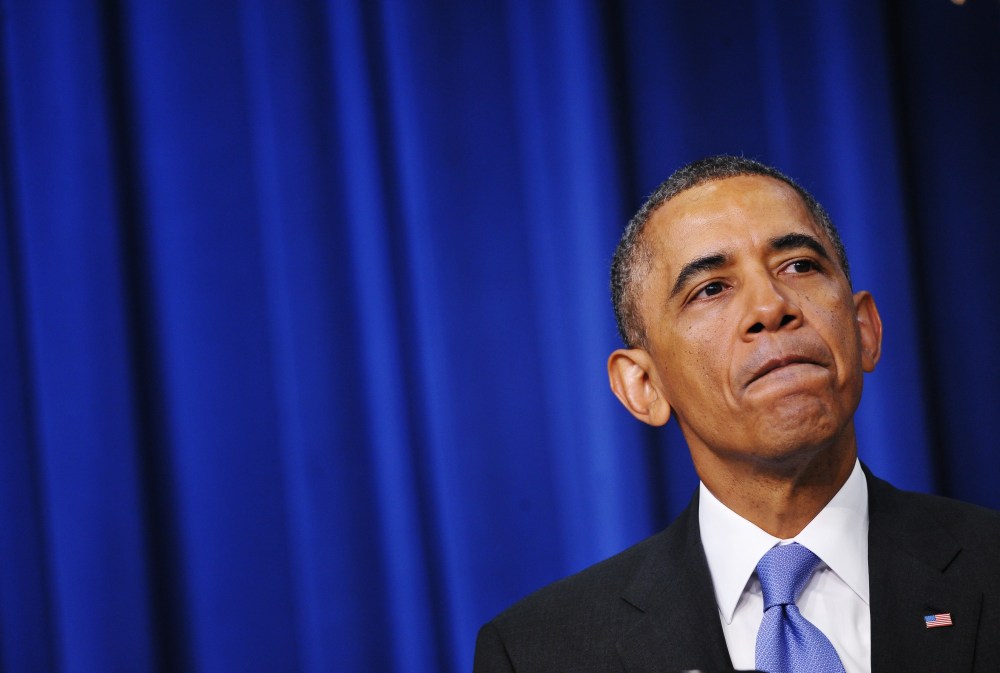 Obama pauses as he speaks during an event on expanding college opportunity, Jan. 16, 2014.