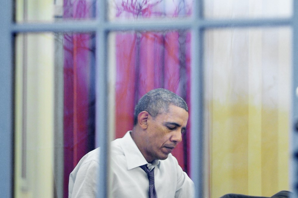 Barack Obama works in the Oval Office of the White House, Jan. 27, 2014.