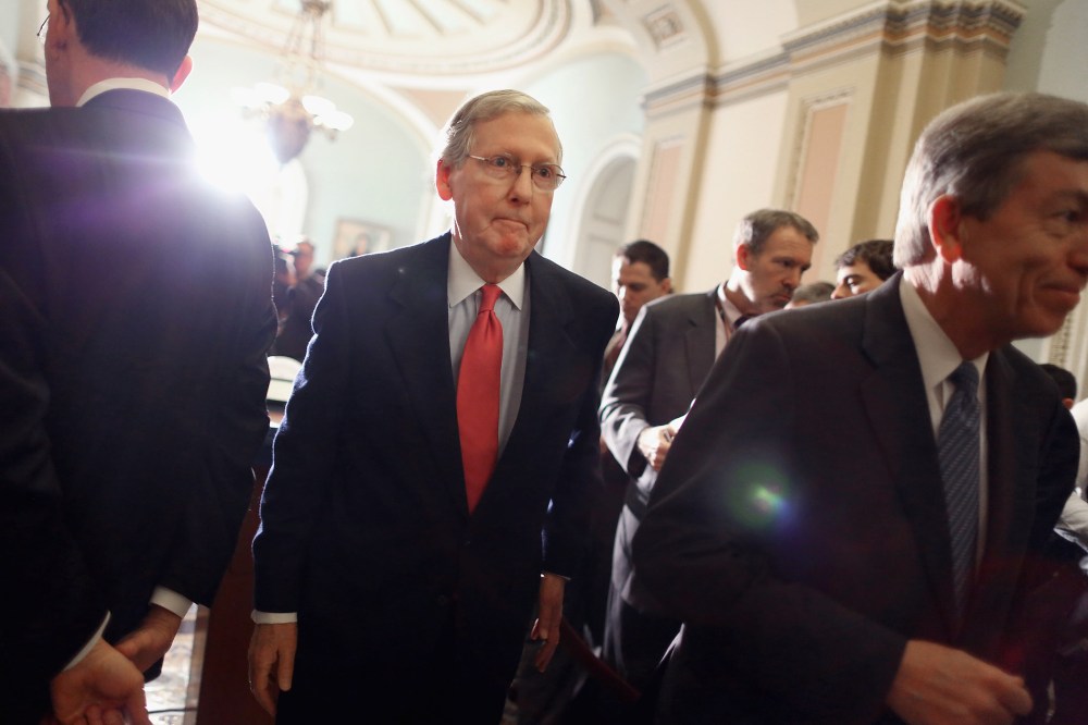 Mitch McConnell leaves after talking with reporters at the U.S. Capitol, Jan. 28, 2014.