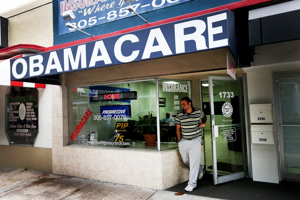Baseel Farah walks out of Leading Insurance Agency as the insurance agency helps enroll people in health insurance plans under the Affordable Care Act in Miami, Feb. 13, 2014.