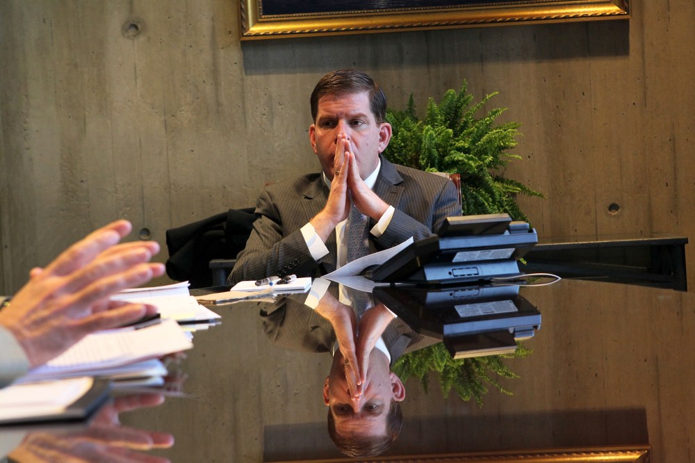 Mayor Marty Walsh listens to Paul Curran and Dave Sussick from the office of Labor Relations, during a meeting in his office, Jan. 28, 2014.