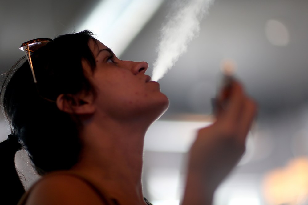 Yenisley Dieppa tries different flavors as she purchases an electronic cigarette at the Vapor Shark store on Feb. 20, 2014 in Miami, Florida.