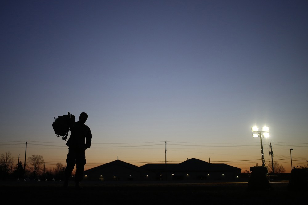 A soldier grabs his rucksack following a homecoming ceremony in Fort Knox, Kentucky.
