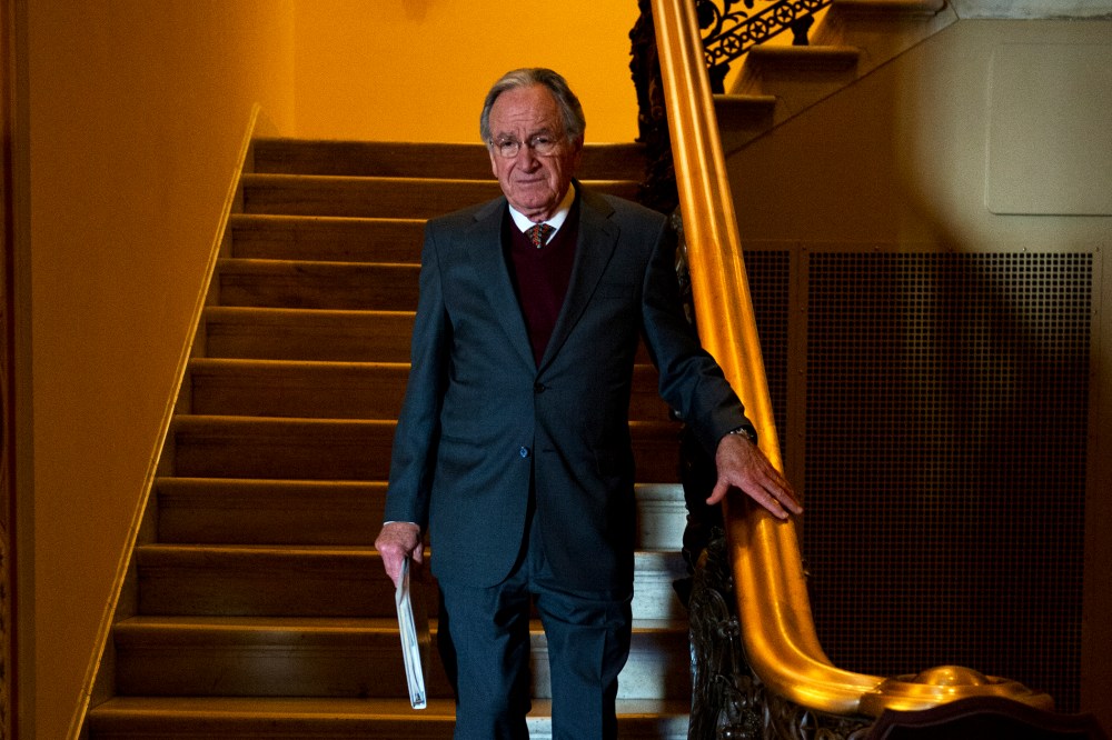 Sen. Tom Harkin descends a stairway to the first floor of the Capitol after the senate luncheons.