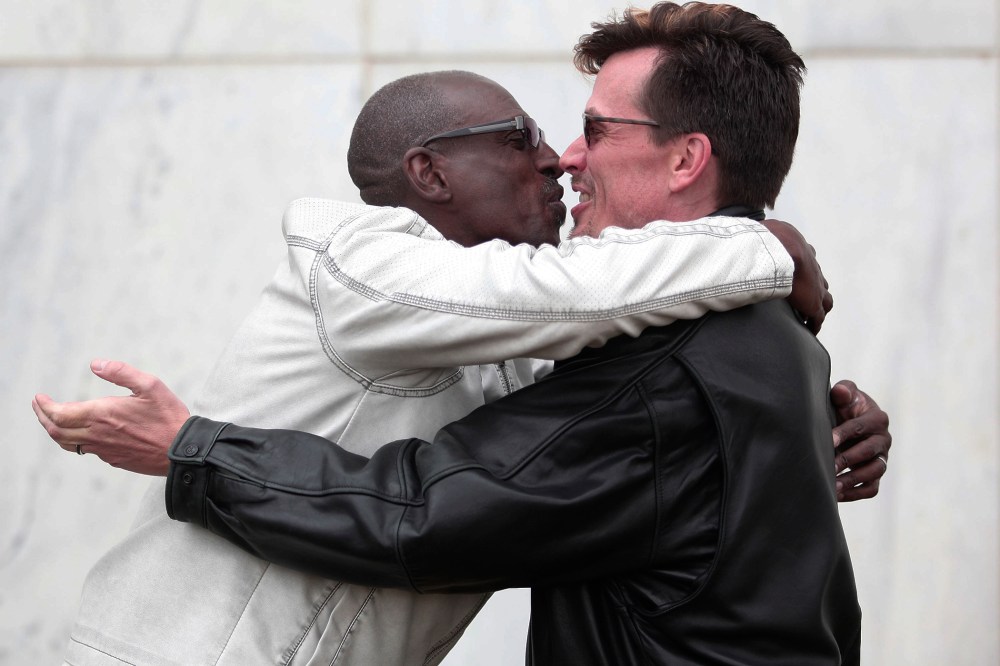 Roland Smith (L) and Paul Mattson (R) of Farmington Hills, MI., kiss after getting married at the Oakland County Courthouse on March 22, 2014 in Pontiac, Mich.
