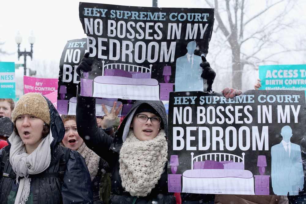 Demonstrators rally outside of the U.S. Supreme Court during oral arguments in Sebelius v. Hobby Lobby, March 25, 2014.
