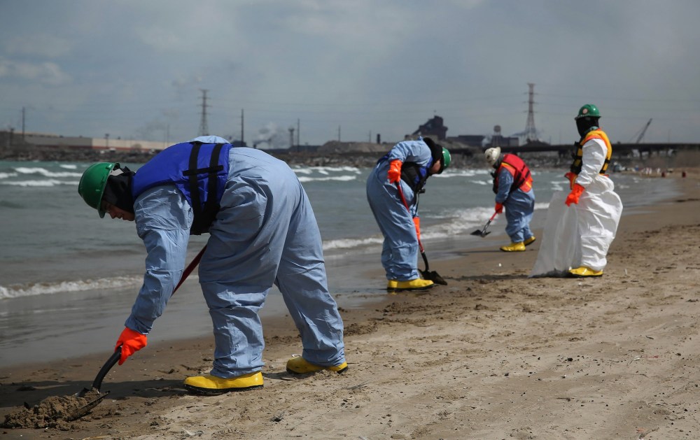 Crews clean up an oil spill along Lake Michigan from the BP Whiting refinery in Whiting, Ind., on Tuesday, March 25, 2014.