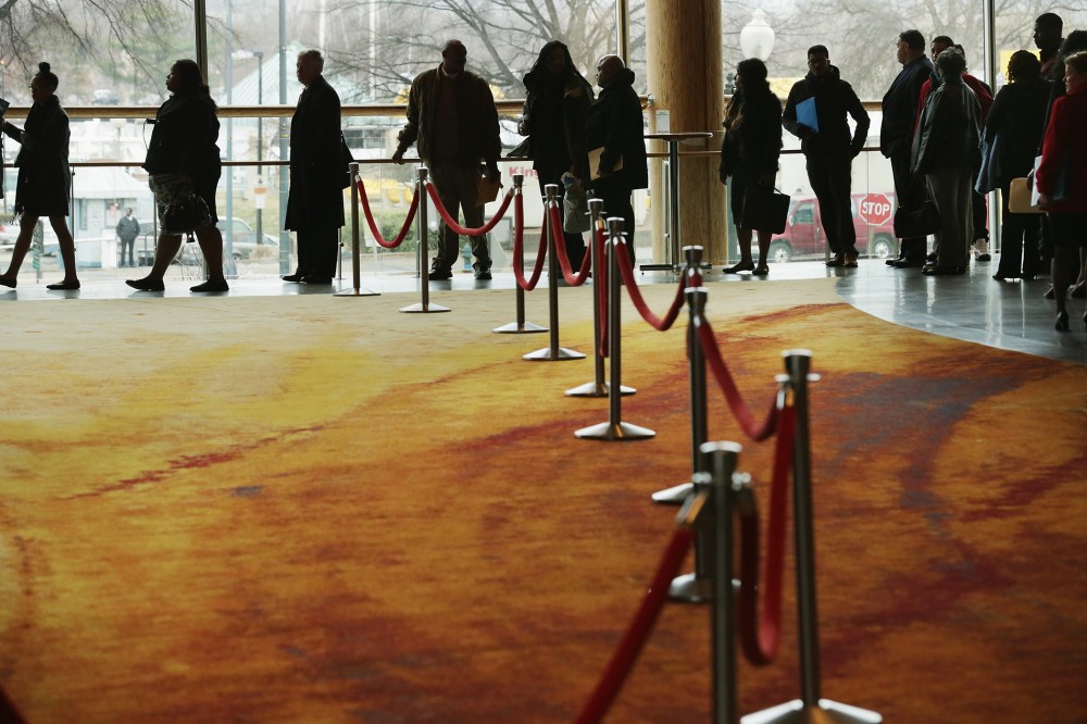 About 1,500 people seeking employment wait in line to enter a job fair, March 28, 2014 in Washington, DC.