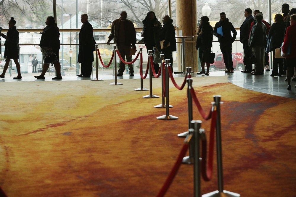 About 1,500 people seeking employment wait in line to enter a job fair in Washington, DC., Mar. 28, 2014.